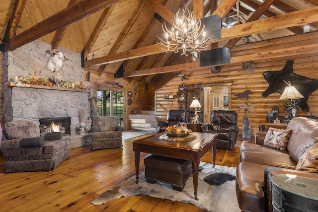 living room with an inviting chandelier, wood-type flooring, a stone fireplace, wooden ceiling, and beamed ceiling