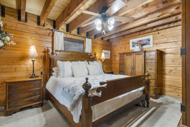 bedroom with beam ceiling, dark carpet, and wooden walls