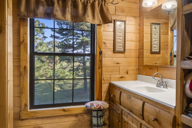 bathroom with vanity and wood walls