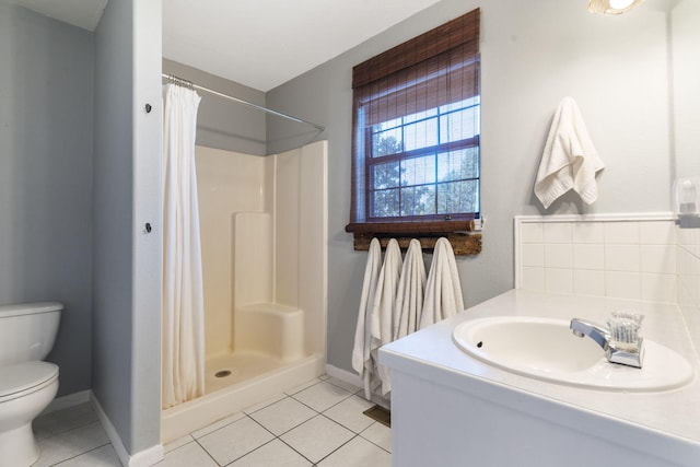 bathroom featuring walk in shower, tile patterned floors, toilet, and vanity