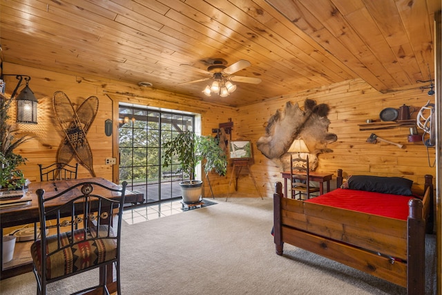 carpeted bedroom featuring wooden walls and wooden ceiling