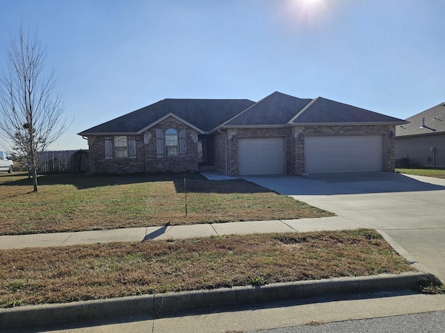 view of front of house with a garage and a front yard