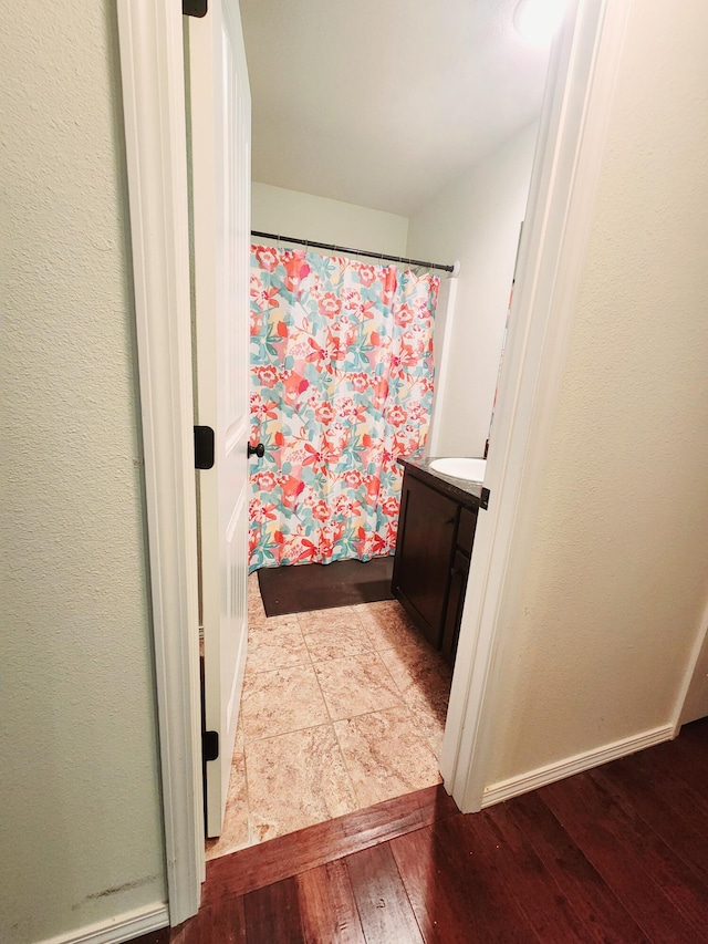 bathroom with a shower with curtain, vanity, and wood-type flooring