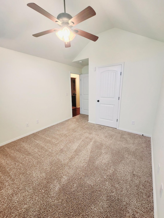 spare room featuring carpet flooring, ceiling fan, and vaulted ceiling