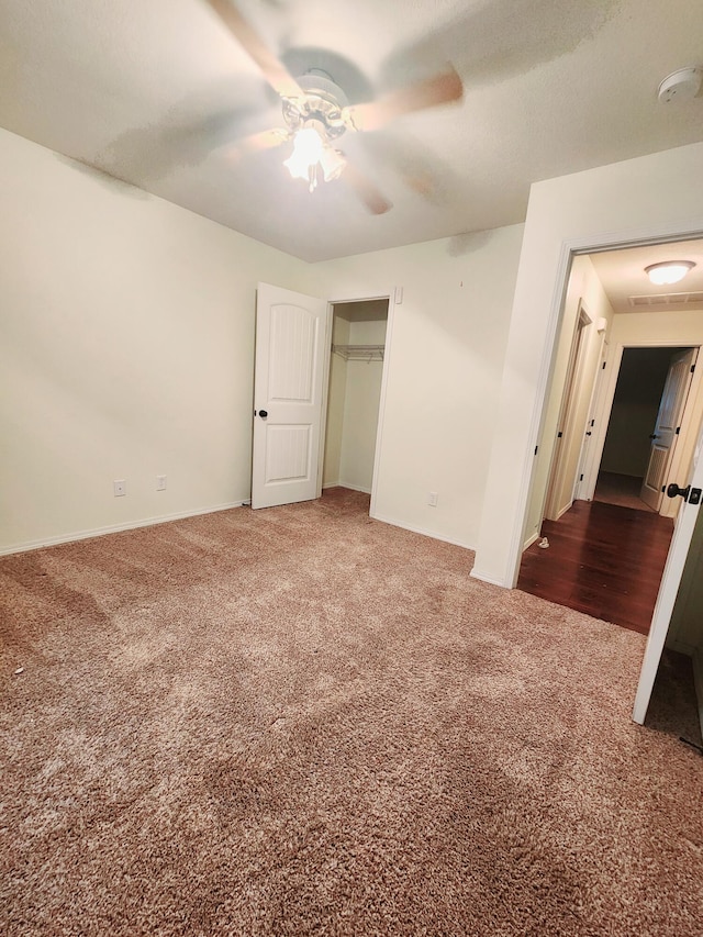 unfurnished bedroom with carpet, a closet, and ceiling fan