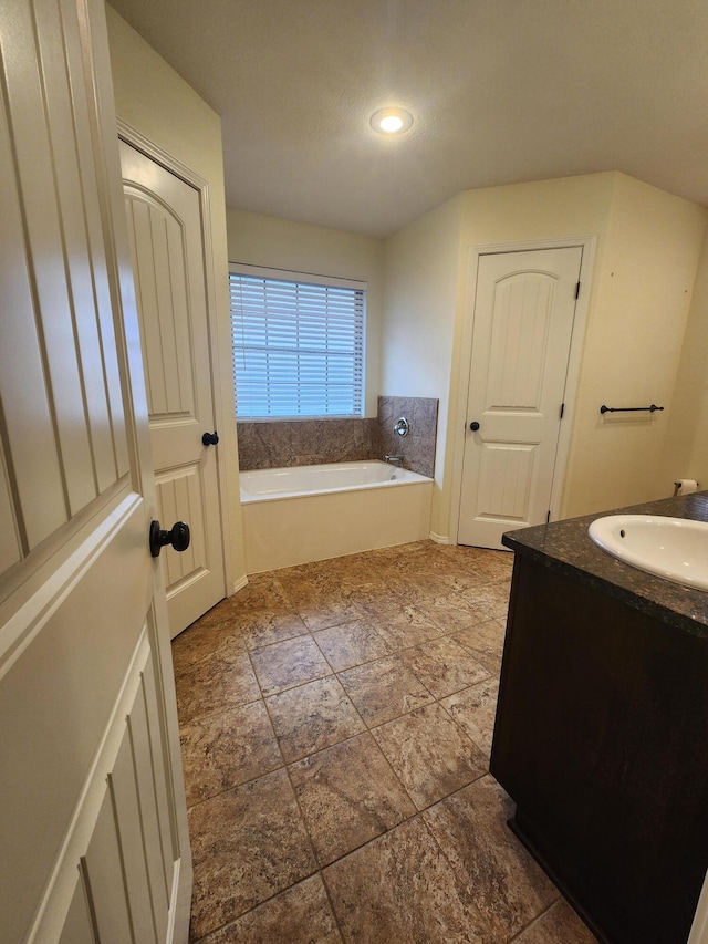 bathroom with a bathtub and vanity