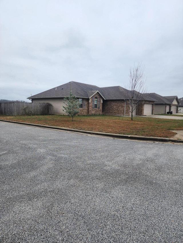 view of front of house featuring a front yard and a garage