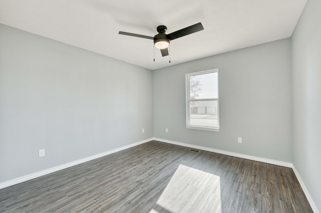 unfurnished room with ceiling fan and dark hardwood / wood-style flooring