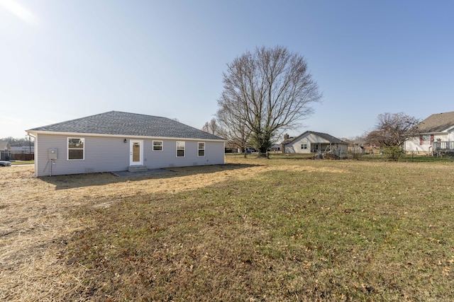 back of house featuring a yard