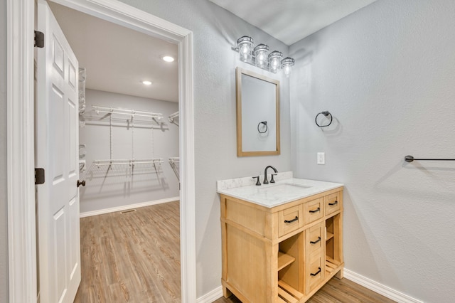 bathroom with vanity and wood-type flooring