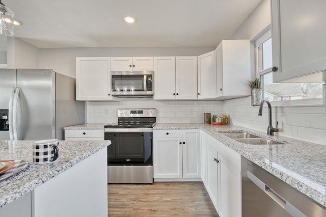 kitchen with sink, white cabinets, and stainless steel appliances