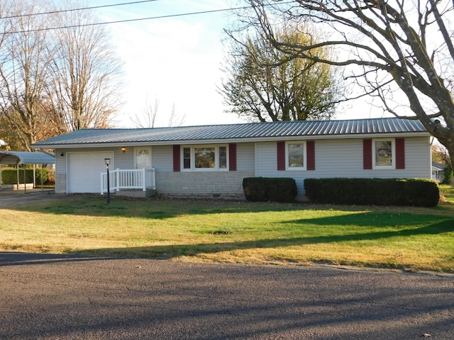 ranch-style house featuring a front yard and a garage