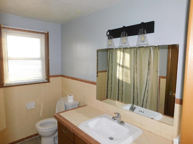 bathroom with toilet, tile walls, and sink