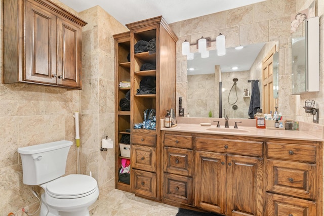 bathroom featuring vanity, toilet, and tile walls