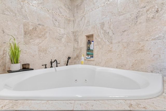 bathroom with a relaxing tiled tub