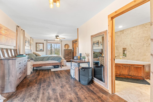 bedroom with ceiling fan, dark wood-type flooring, and tile walls