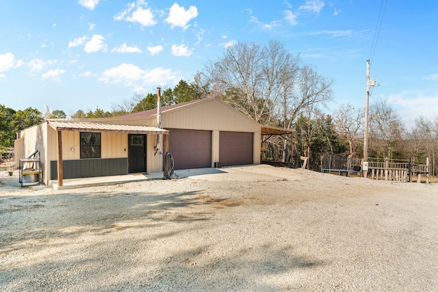 view of property exterior featuring an outbuilding and a garage