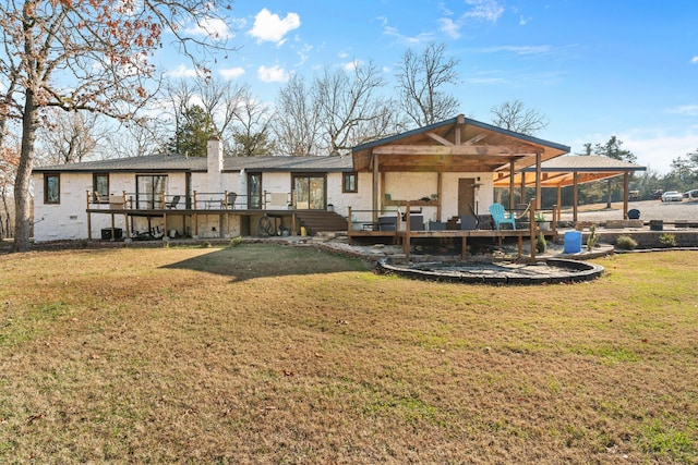 back of house with a yard and a wooden deck