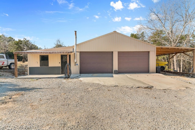 view of front of house featuring a garage and a carport