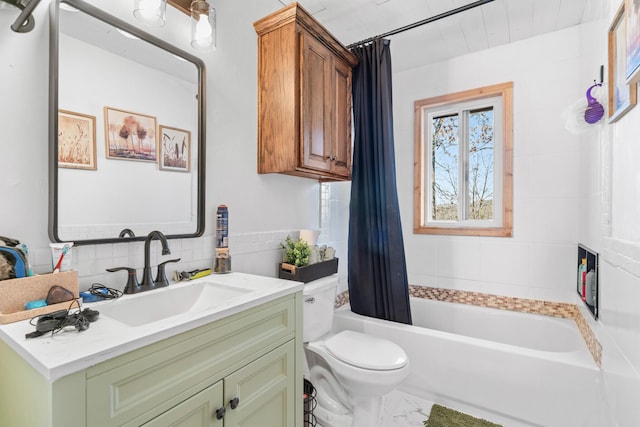 full bathroom featuring shower / bath combo, vanity, toilet, and tile walls