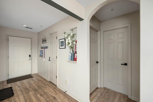 entrance foyer with hardwood / wood-style flooring and a textured ceiling