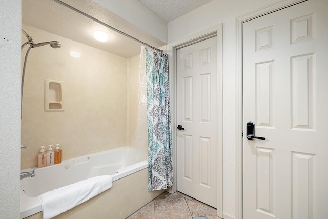 bathroom featuring tile patterned floors, shower / bath combination with curtain, and a textured ceiling