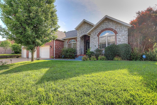 view of front of home with a front yard and a garage