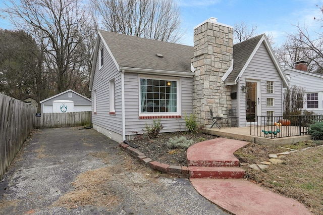 view of front facade featuring a patio, an outdoor structure, and a garage