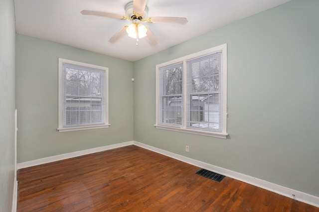 spare room with ceiling fan and dark wood-type flooring