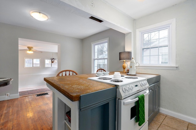 kitchen with kitchen peninsula, white electric stove, and ceiling fan