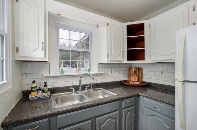 kitchen with sink, gray cabinets, white fridge, tasteful backsplash, and white cabinets