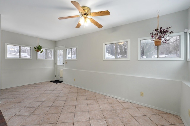 tiled empty room with ceiling fan