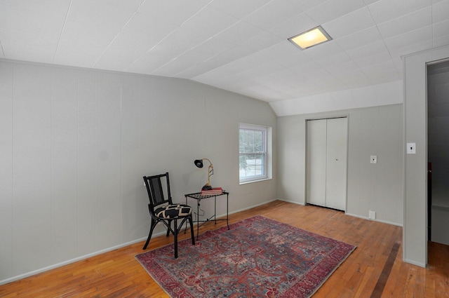 living area featuring wood-type flooring and lofted ceiling