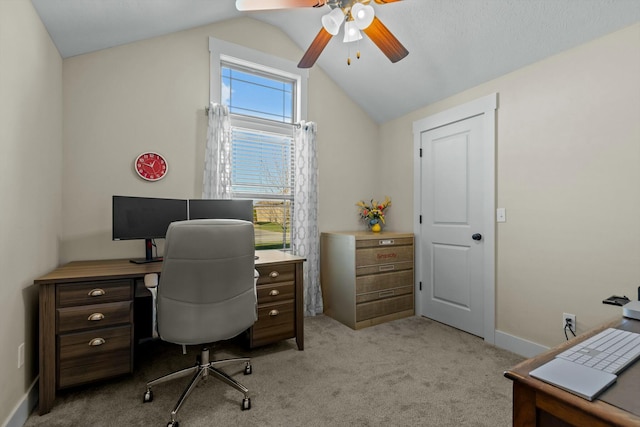 home office featuring light carpet, ceiling fan, and vaulted ceiling