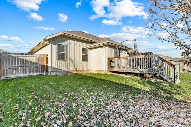 view of side of home with a lawn and a deck