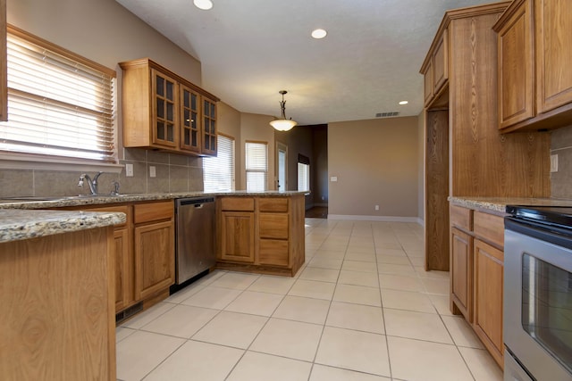 kitchen featuring decorative backsplash, dishwasher, white electric range oven, and light stone counters