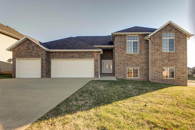 view of front of property with a garage and a front lawn