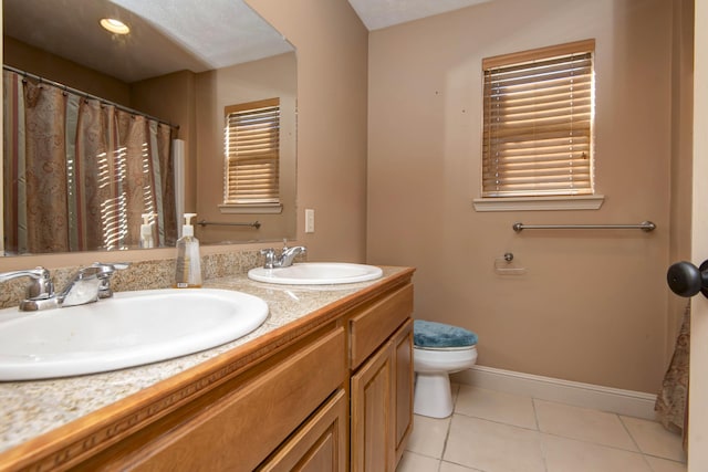 bathroom featuring tile patterned floors, vanity, and toilet