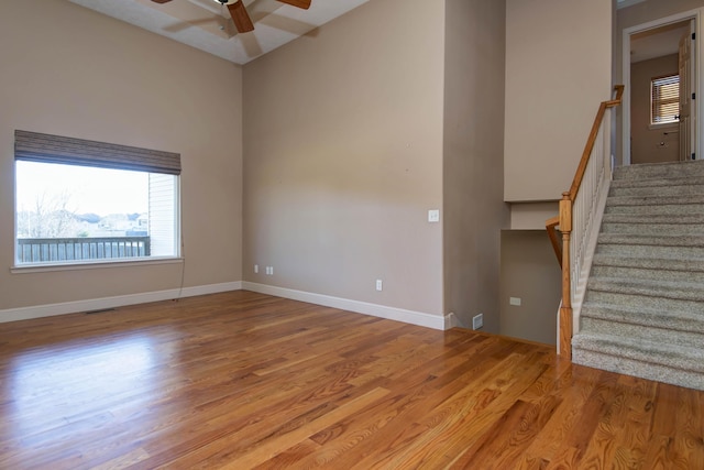 empty room with light hardwood / wood-style floors and ceiling fan