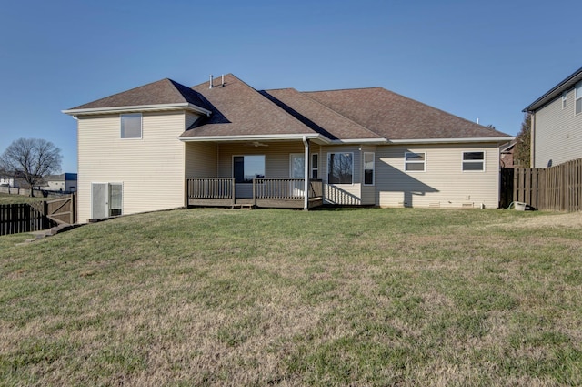 rear view of property featuring a yard and a deck