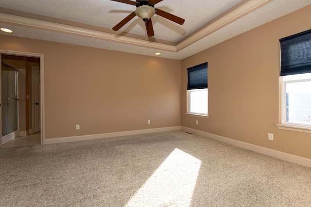 unfurnished room featuring carpet flooring, ceiling fan, a raised ceiling, and a textured ceiling