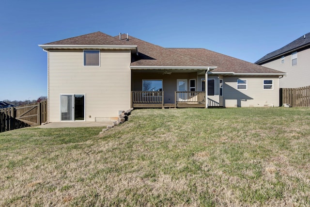 back of house featuring a yard, a patio area, and a wooden deck