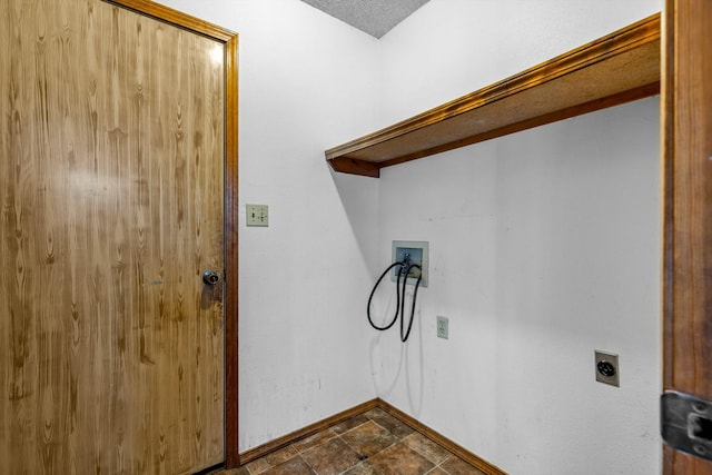 laundry room with hookup for an electric dryer, a textured ceiling, and hookup for a washing machine