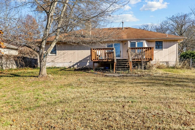 back of property featuring a lawn and a wooden deck