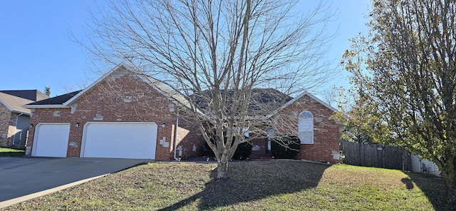 view of front property featuring a garage and a front lawn