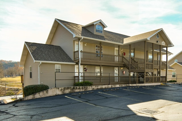 14 Scenic Ct Unit 8, Branson, MO 65616 - exterior space featuring uncovered parking, roof with shingles, fence, and covered porch