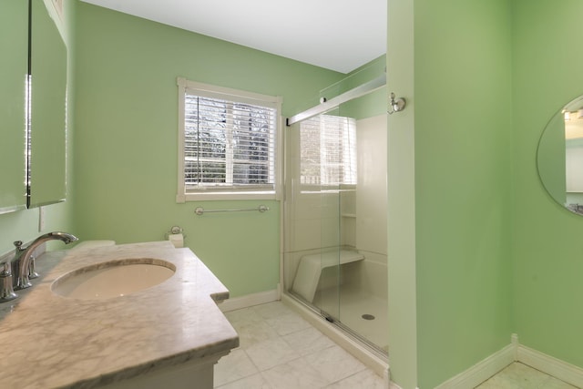 bathroom with tile patterned flooring, vanity, and an enclosed shower