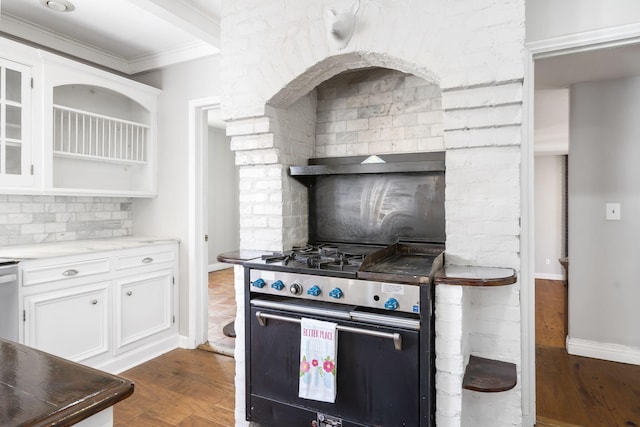 kitchen with white cabinets, dark hardwood / wood-style flooring, crown molding, and stainless steel gas range