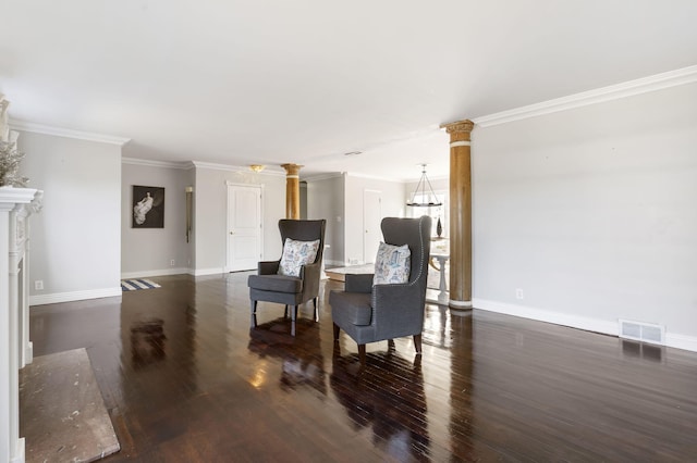 living area with crown molding, dark wood-type flooring, and ornate columns