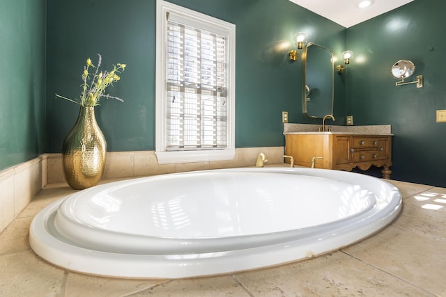 bathroom featuring vanity and a relaxing tiled tub